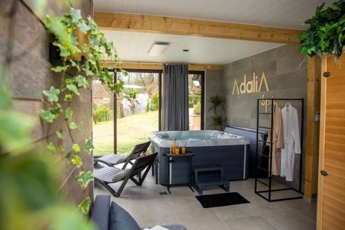 a bath tub sitting on a patio with furniture at Holiday Home AdaliA in Štrigova