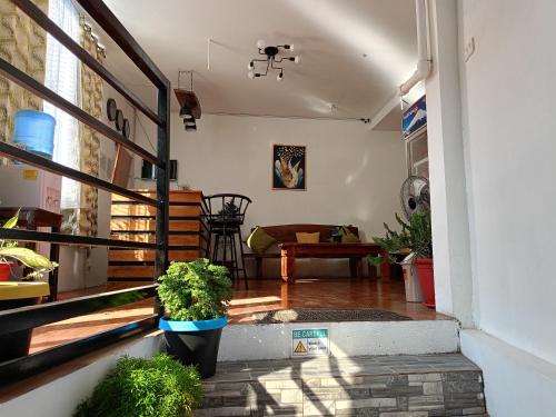 a view of a living room with plants in theoyer at Alec Lodge in Coron