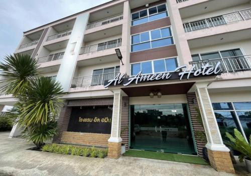 a hotel with a sign on the front of it at Al Ameen Hotel in Krabi