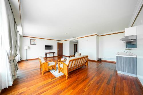 a living room with a couch and a table at Pursat Riverside Hotel & Spa in Pursat