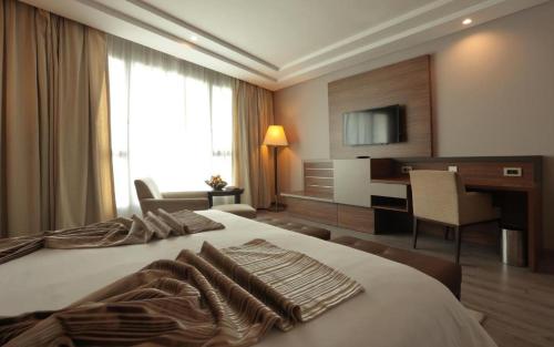 a hotel room with a bed and a desk at Le Palace d'Anfa in Casablanca