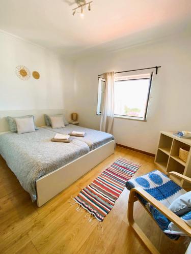 a bedroom with a large bed and a window at House near Ribeira with Garden, Terrace & Yoga Studio in Santo Isidoro