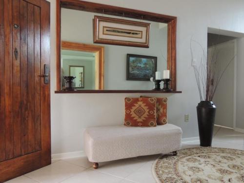a room with a mirror and a bench with a pillow at Gentle Breeze Retreat in Parys