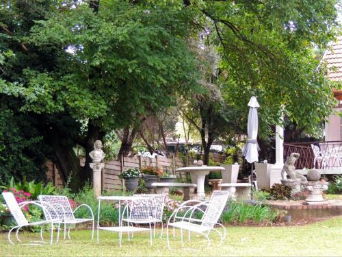a group of chairs and a table and an umbrella at Gentle Breeze Retreat in Parys