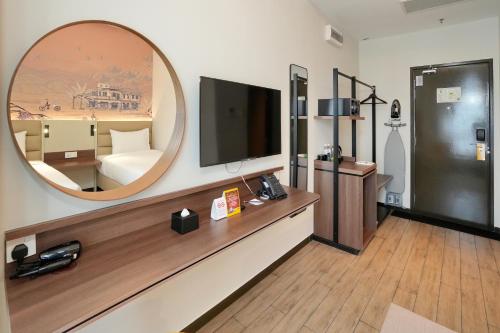 a living room with a large mirror and a tv at Cititel Express Ipoh in Ipoh