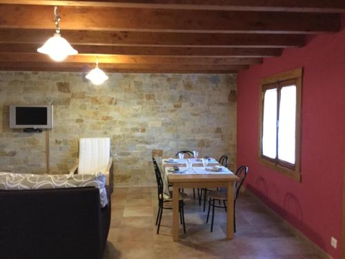 a dining room with a table and chairs at El Mirador de los Trobos in Villar de Otero