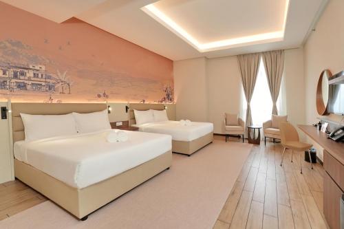 a hotel room with two beds and a television at Cititel Express Ipoh in Ipoh