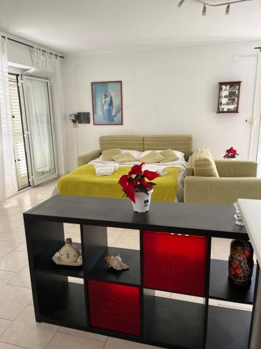 a bedroom with a bed and a table with red cabinets at Villa Cecilia in Pozzuoli