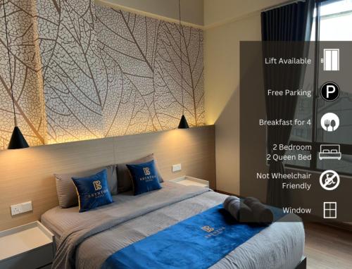 a bedroom with a large bed with blue pillows at Hotel Brynton at Cameron Centrum Mall in Cameron Highlands