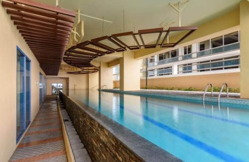a pool in a building with a swimming pool at Grand Riviera suite Condotel in Manila