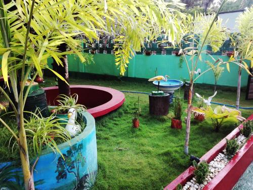um jardim com vasos de plantas e árvores em Neem Forest Guest House & Yoga Meditation Centre em Batticaloa