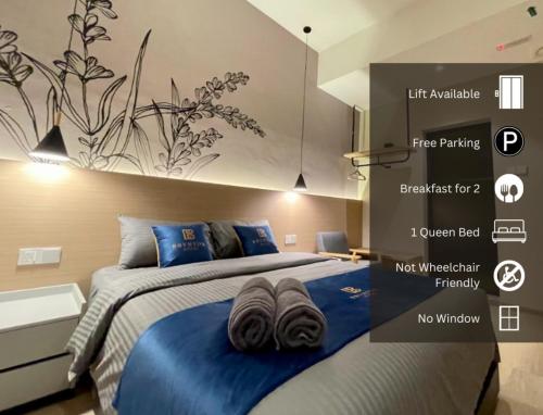 a bedroom with two beds with blue pillows on it at Hotel Brynton at Cameron Centrum Mall in Cameron Highlands