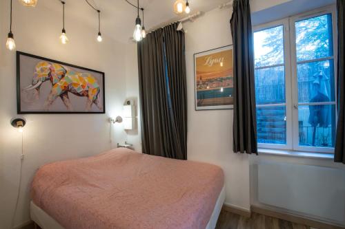 a bedroom with a bed with a painting of an elephant at Suite du Vieux Lyon Cosy & calme - le Quarantaine in Lyon