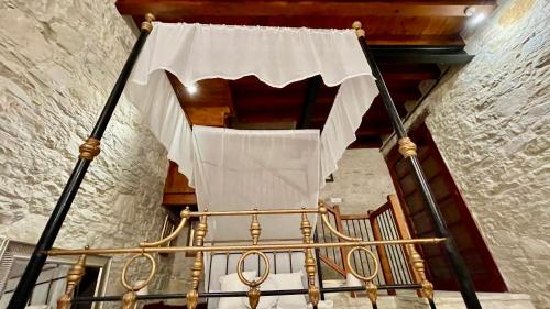 a stairway with a white curtain on top of a staircase at Juliet Suite by TrulyCyprus in Doros