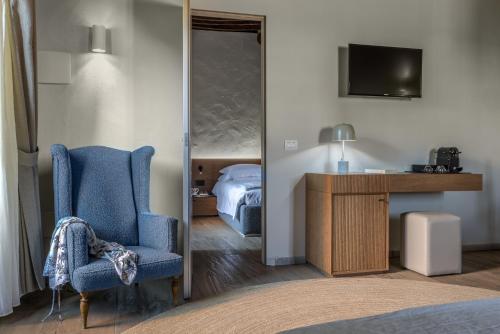 a bedroom with a bed and a chair and a desk at Salvadonica in San Casciano in Val di Pesa