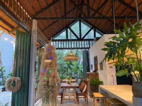 a living room with a table and a dining room at Nhà Lúa Homestay in Ninh Binh