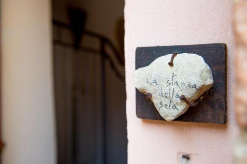 a rock with writing on it on a wall at Torre della Botonta in Castel Ritaldi