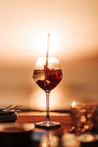 a glass of wine sitting on a table at Sofitel Golfe d'Ajaccio Thalassa Sea & Spa in Ajaccio