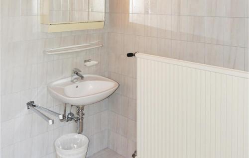 a white bathroom with a sink and a toilet at Stunning Apartment In Wagrain With Kitchen in Wagrain