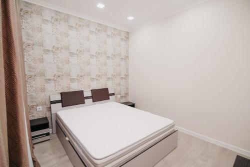 a small bedroom with a white bed in it at ApartHotel City Centrum in Chişinău