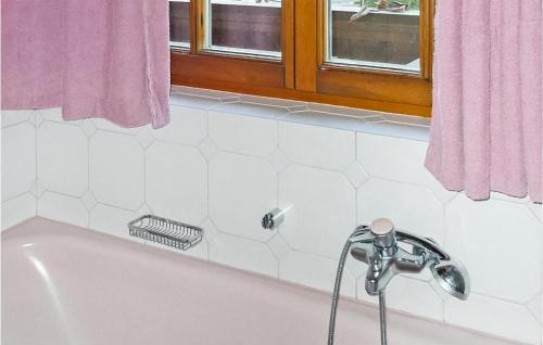 a bath tub with a faucet in a bathroom at Awesome Apartment In Grossarl With 4 Bedrooms And Wifi in Grossarl