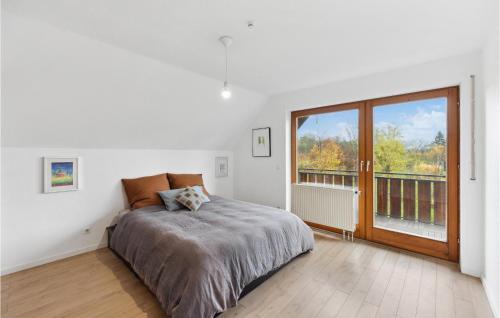 a bedroom with a bed and a large window at Amazing Apartment In Kehl-bodersweier With Wifi 
