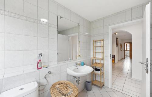 a white bathroom with a sink and a mirror at Amazing Apartment In Kehl-bodersweier With Wifi 