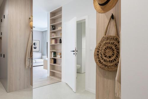 two views of a bathroom and a hallway with a door at Apartament Redłowska Kępa nad Morzem in Gdynia