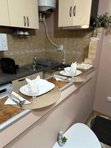 a kitchen counter with two plates and napkins on it at Cozy Apartament in Galaţi