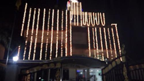 a tall building with lights on it at night at Hotel Shelter Inn,Chhatarpur in Chhatarpur