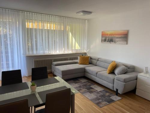 a living room with a couch and a table at George-Beach Apartment Ossiachersee/Gerlitzen in Bodensdorf