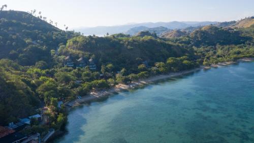 an aerial view of a river with houses and trees at Plataran Komodo Resort & Spa - CHSE Certified in Labuan Bajo