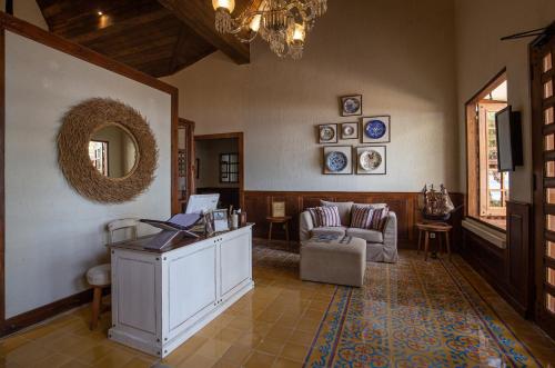 a living room with a couch and a mirror at Plataran Komodo Resort & Spa - CHSE Certified in Labuan Bajo