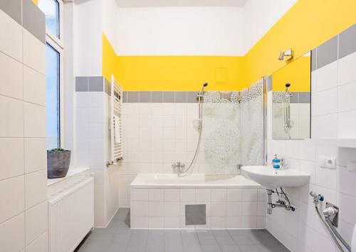 biała łazienka z umywalką, wanną i umywalką w obiekcie Exclusive Apartment City Center w Wiedniu