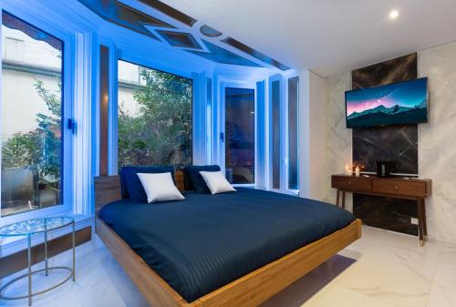 una camera con un letto blu e una finestra di ART & SPA Luxury bedroom at the heart historical center a Mulhouse