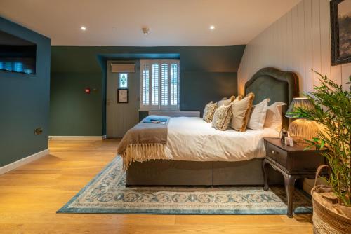 a bedroom with a large bed and a table at The Northey Arms in Box