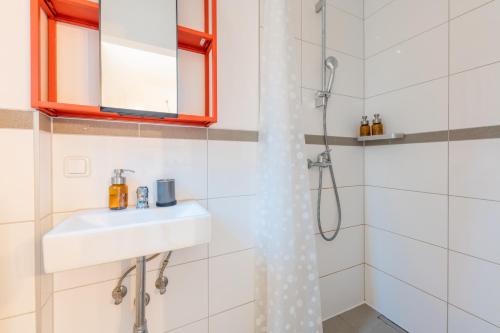 a bathroom with a sink and a shower at Urban Retreat by stay awesome in Kassel