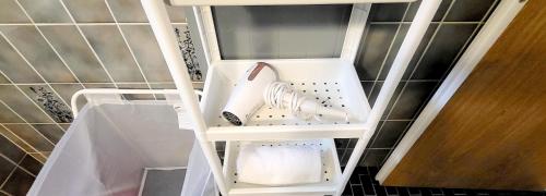 a white shoe in a shelf in a refrigerator at ApartaHotel L'escapade Urbaine in Lausanne