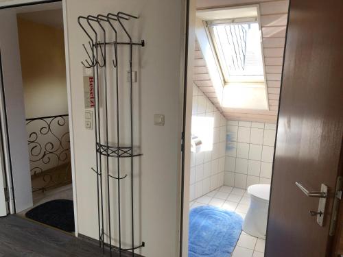 a bathroom with a toilet and a bathroom with a window at 3 separate Messe Appartements bis zu 11 Personen in Ratingen