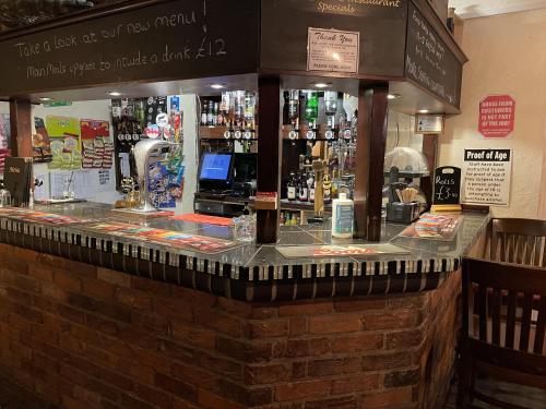 a bar with a lot of bottles of alcohol at The Riverside in Sutton Bridge