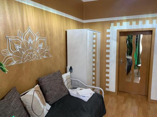 a room with a bed and a door with a mirror at Best-Preis FEWO Rathausblick 2 - Zentrale Lage in Wittenberge - 2 Personen - Einzelzimmer - Vollausstattung - WLAN / Prime & Self-Check-In in Wittenberge