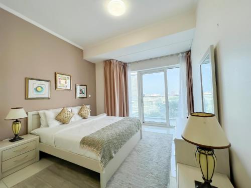 a bedroom with a bed and a large window at Luton Vacation Homes -sea view -Damac Heights, Dubai Marina -90AB2 in Dubai