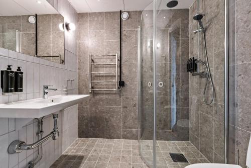 a bathroom with a shower and a sink at Dalecarlia Hotel & Spa, BW Premier Collection in Tällberg