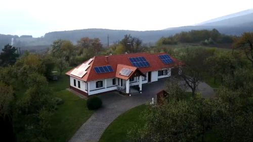 a house with solar panels on its roof at Csonkás Kúria Vendégház Zemplén in Mogyoróska