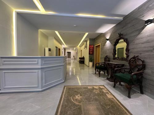 a hallway with a dining room with a table at The Garden Hotel in Islamabad