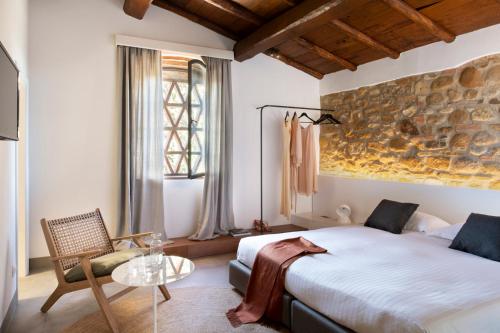 a bedroom with a large bed and a glass table at Salvadonica in San Casciano in Val di Pesa