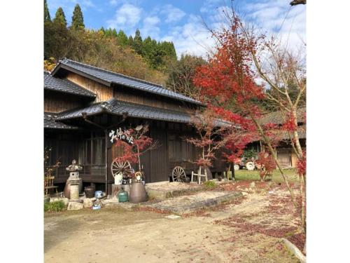 a japanese house with red trees in front of it at Shotyu No Yakata / Vacation STAY 49506 in Saga