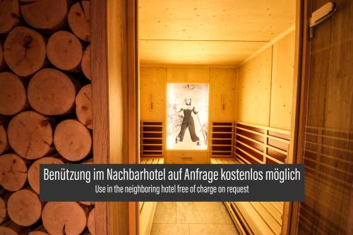 a hallway in a building with a picture of a man at SKILL Mountain Lodge - Ski und Bike Hostel inklusive JOKER CARD in Saalbach Hinterglemm