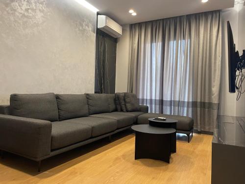 a living room with a couch and a table at Tirana LUX Apartments in Tirana