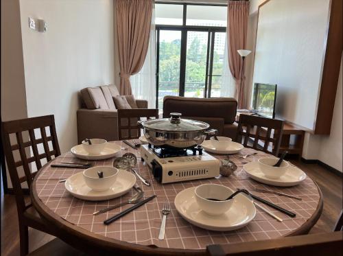 a dining room table with a pot on a stove at NEW 6pax 3BR Sunrise view 100m Attractive Places Kea Farm in Cameron Highlands